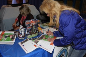 Signing autographs is just one part of a celebrity's job. Ann helps Thunder out because those horseshoes can be a bit tricky. Photo courtesy of Arabian Horse Association.