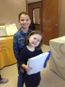 Lead line exhibitor, Addison Meilleur, and Small Fry exhibitor, Alyssa Papiez, are excited about turning in their entries in the show office.