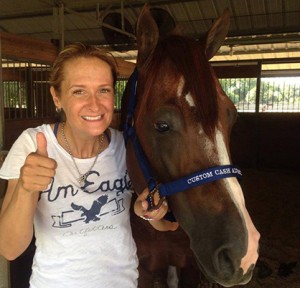 Custom Cash Advance poses with his personal groom, Jenny Ricotta. Photo courtesy of Silver Spurs Equine. 