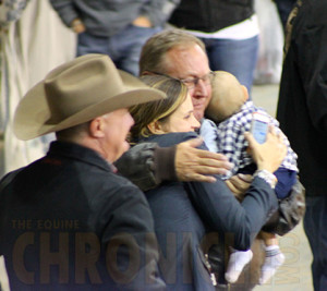 Husband Larry Lansch, daughter Courtney Brockmuller, and grandson Brim share a group hug following Granbdma's big win.
