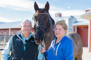 John and Leslie Malone pose with Maikel at Harmony Sporthorses. Photo courtesy of Colorado State University.
