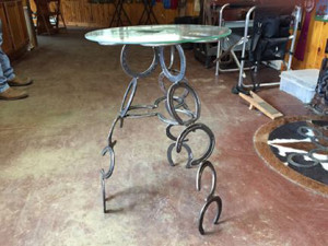 Horse shoe table with glass top.