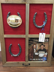 A custom made buckle display with championship photo area. Made and donated by Chris Stassi. 