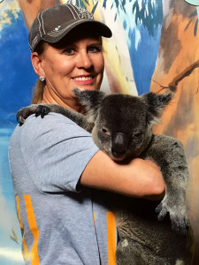 Charlene posing with a different kind of furry four-legged creature.