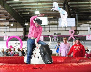 Pat Heeley riding the mechanical bull during the March To The Arch Exhibitor's Party. Photo courtesy of Shane Rux. 