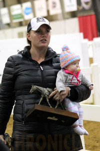 Baby Charlotte helping Mom carry trophies. 