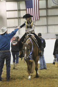 Susan Roberts and John share a fist bump as she exits the pen at the 2015 QH Congress.